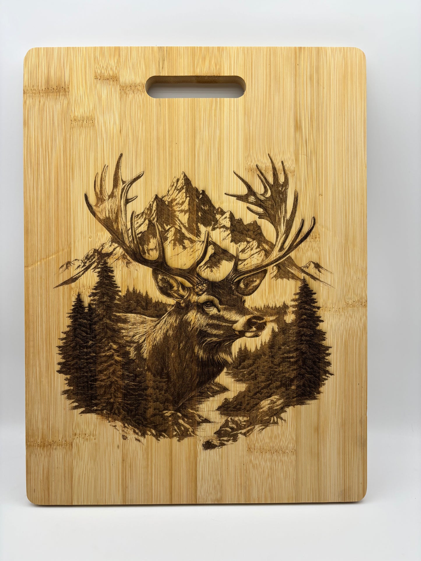 Bamboo cutting board with a deer scene.