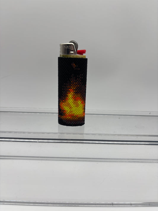 Beaded lighter cover with flames.
