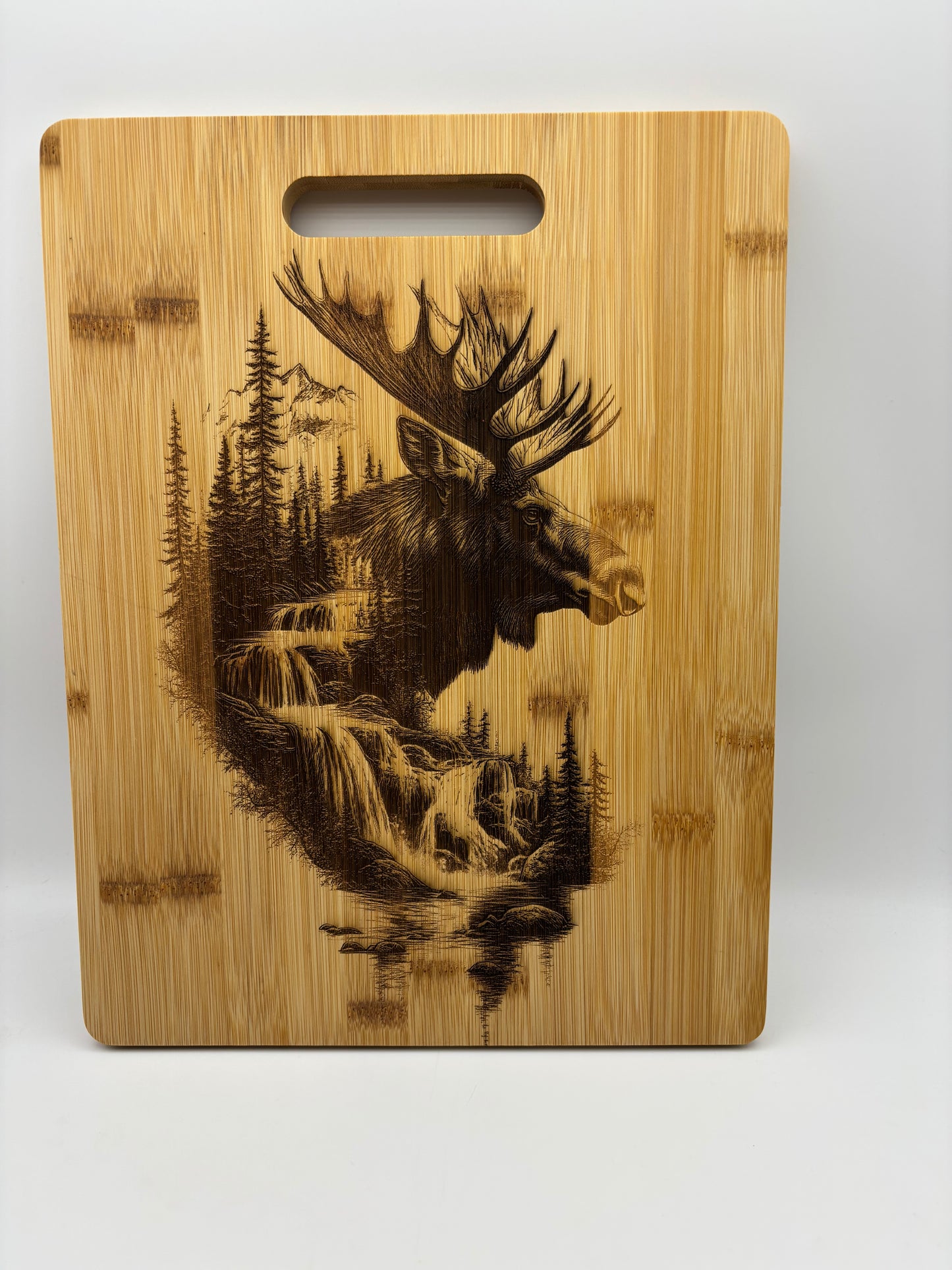 Bamboo cutting board with Moose scene engraved on it