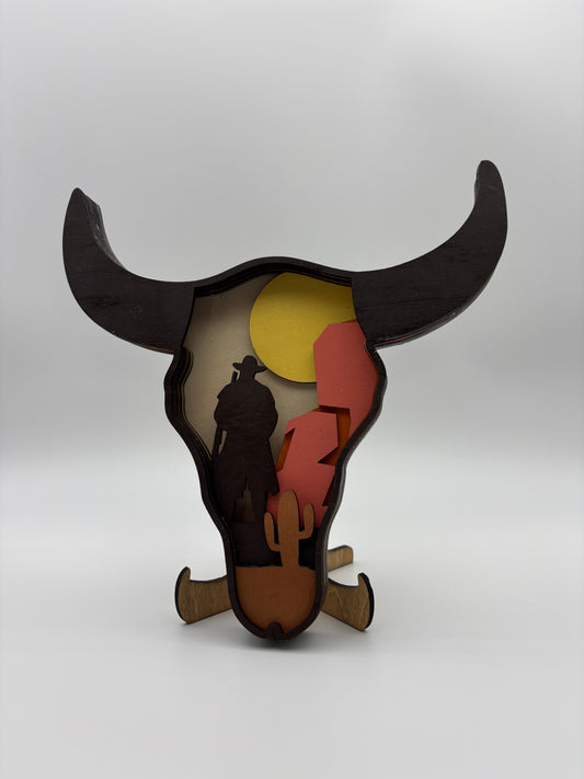Cow skull with western scene.